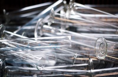 Clear glass laboratory pipettes lying in a loose pile.
